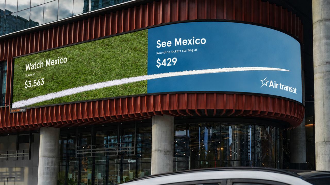 A curved digital billboard split in two. The left half shows green grass with the text 'Watch Mexico — Tickets at $3,563'. The right half shows a blue sky with 'See Mexico — Roundtrip tickets starting at $429' and the Air Transat logo. A white plane contrail crosses both panels along the seam.